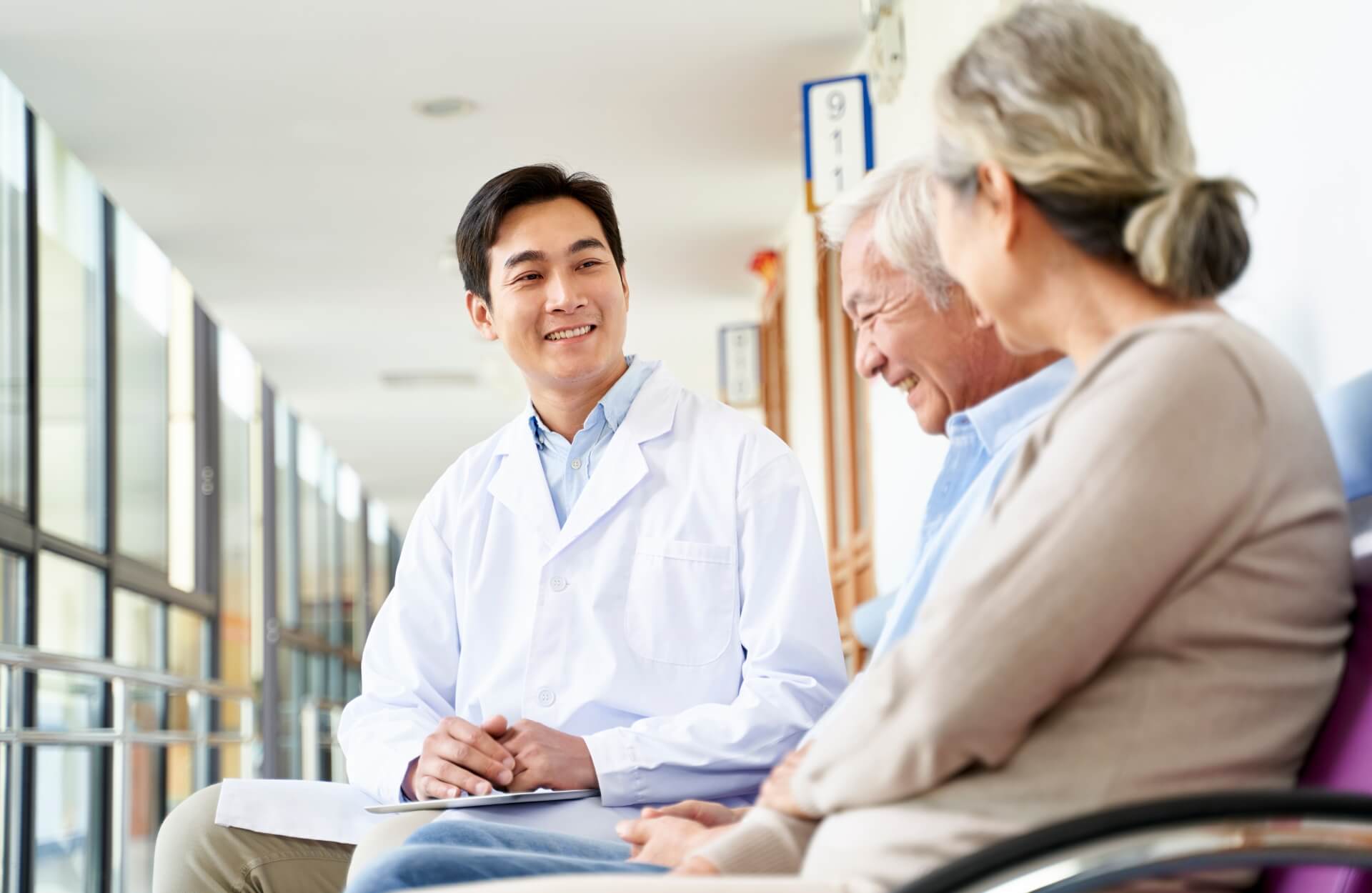 A doctor speaing with an older couple